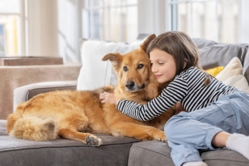 Child and dog on couch