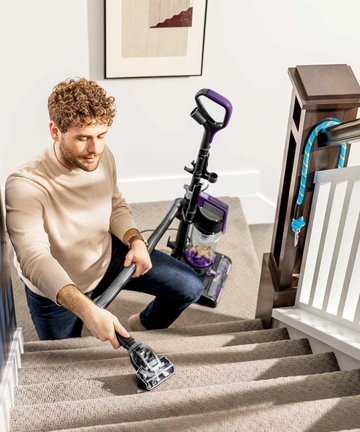 Using Pet TurboBrush Tool on end of hose to vacuum stairs.