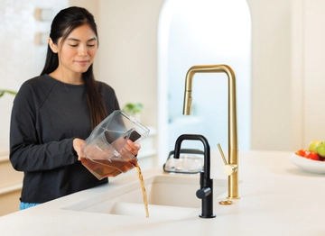 Little Green HydroSteam Portable Cleaner’s dirty water being emptied into sink.