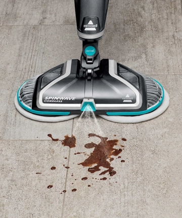 SpinWave Cordless Spin Mop Spraying sticky mess on tile flooring.