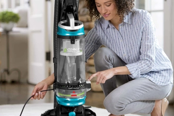 Rewiding cord back into CleanView Swivel Rewind Pet Vacuum.