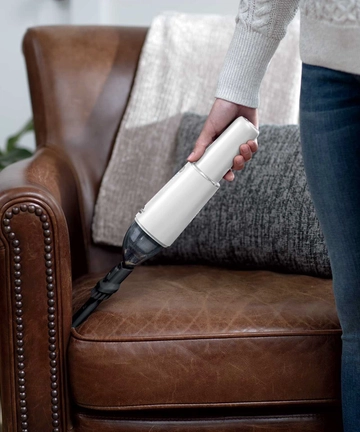 Using TurboSlim Hand Vac with 2-in-1 Crevice Tool to vacuum couch cushion