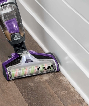 CrossWave Pet Pro Wet Dry Vac vacuuming pet hair along baseboards 