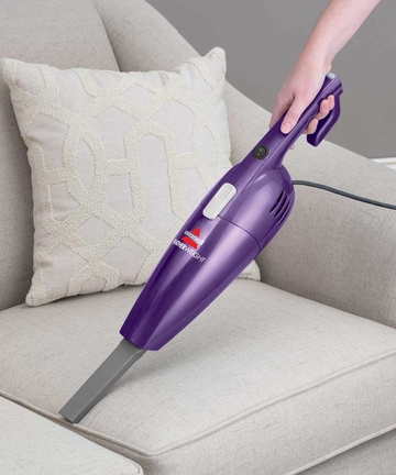 Using Hand Vac with Crevice Tool to vacuum couch cushion.