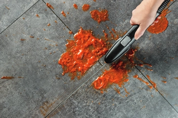 Little Green HydroSteam Portable Cleaner cleaning sauce off tile.