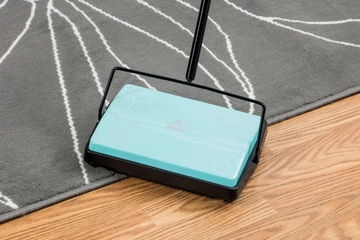 REFRESH Manual Sweeper cleaning on hard floor and area rug.