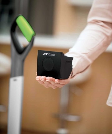 Holding Battery of AirRam Cordless Vacuum in Hand