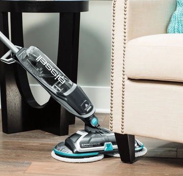 SpinWave Cordless Spin Mop Mopping around and under furniture.