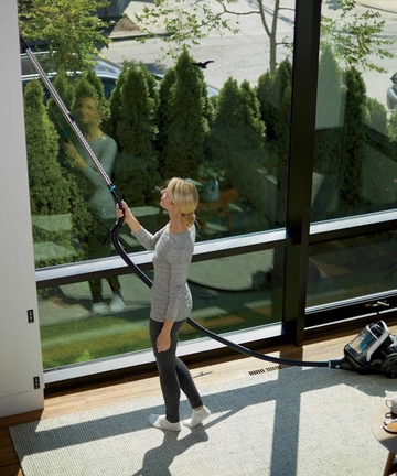 Using Smart Clean Canister Vacuum Extension Wand to Vacuum above floors.   