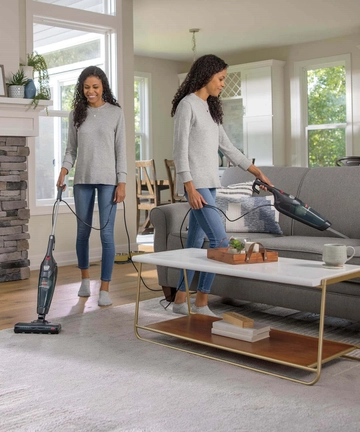 Using Featherweight Stick Vac to vacuum area rug and couch cushions