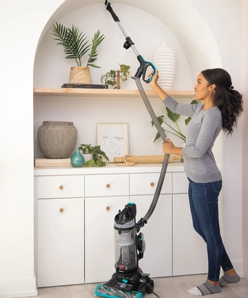 Using CleanView Swivel Pet Reach hose and extension wand to vacuum book shelf