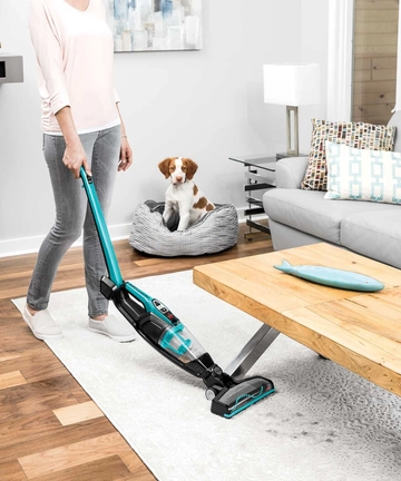 Using ReadyClean Cordless Sick Vac bending handle to vacuum under table. 