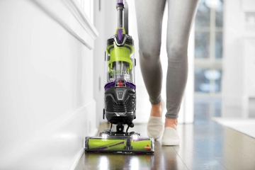Using Pet Hair Eraser Turbo Plus Vacuum to vacuum along baseboard.