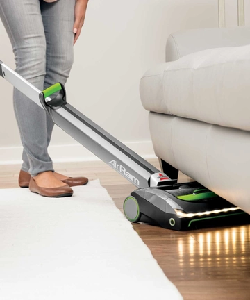 Using AirRam Cordless Vacuum to vacuum under furniture with LED headlights   