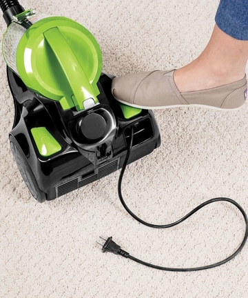 Rewinding cord back into Zing Bagless Canister Vacuum.