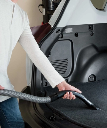 Using Tool on end of hose to vacuum car interior.