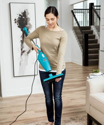  Holding FeatherWeight Stick Vac to add floor nozzle