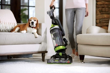 Using CleanView Swivel Pet Vacuum cleaner to clean in between furniture.