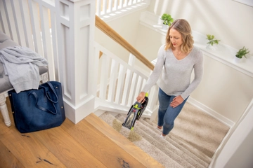 Using Pet Stain Eraser Portable Cleaner to clean stain on stairs. 