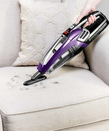 Using Dusting Brush with Pet Hair Eraser Hand Vac to vacuum couch cushi 