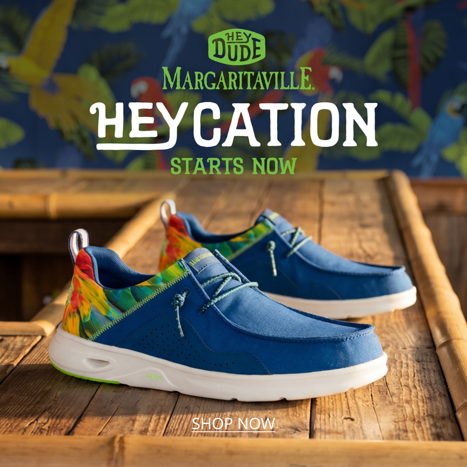 A pair of Margaritaville themed men's Wally Heydude slip-ons sitting on top of a wooden bar