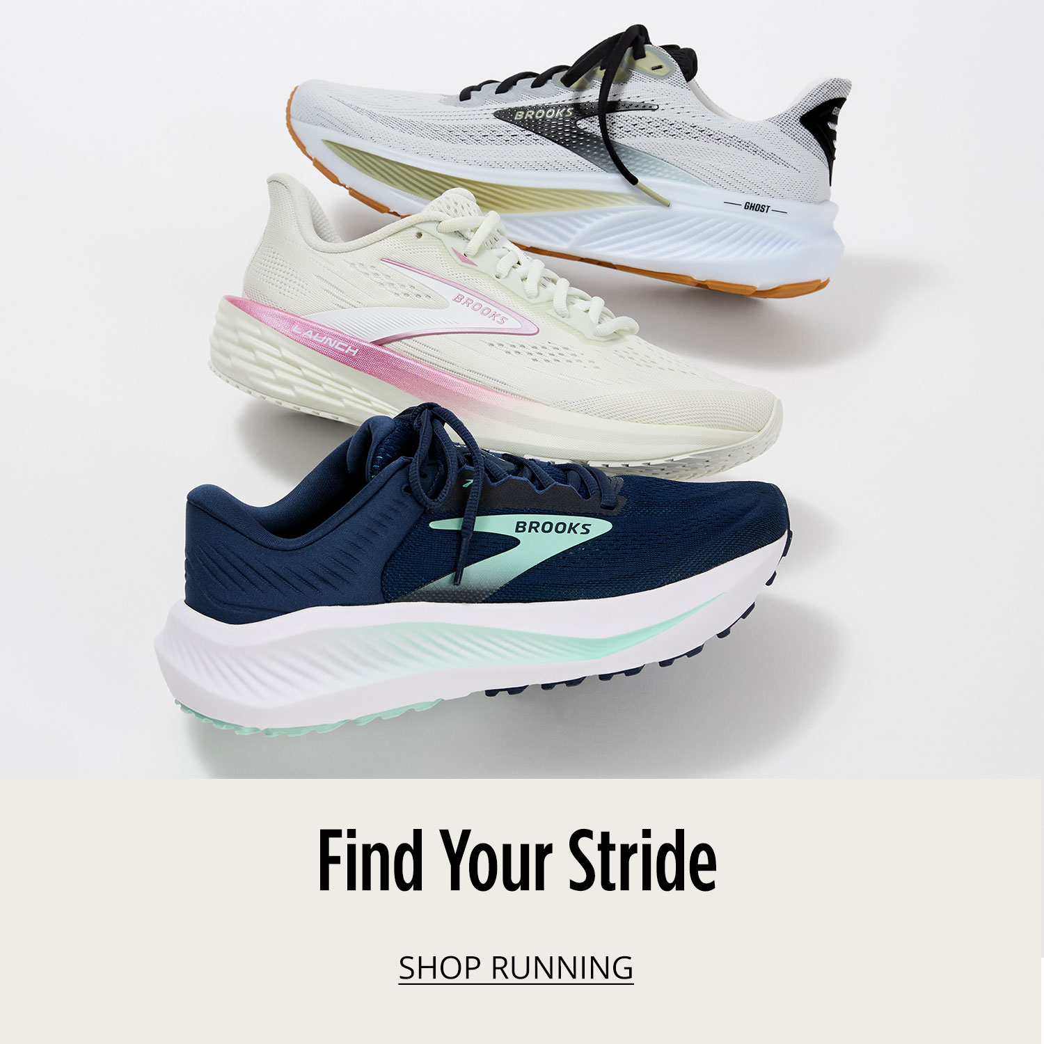 Three different Brooks athletic running shoes are vertically lined up and slightly on top of each other on white background