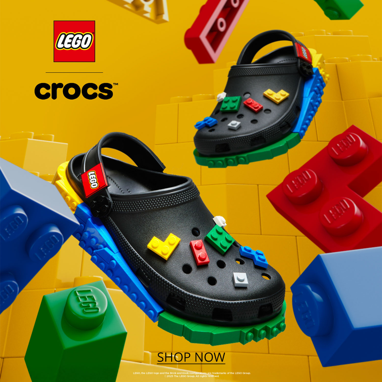 A pair of Lego themed Crocs against a yellow background with assorted colored Lego bricks around them