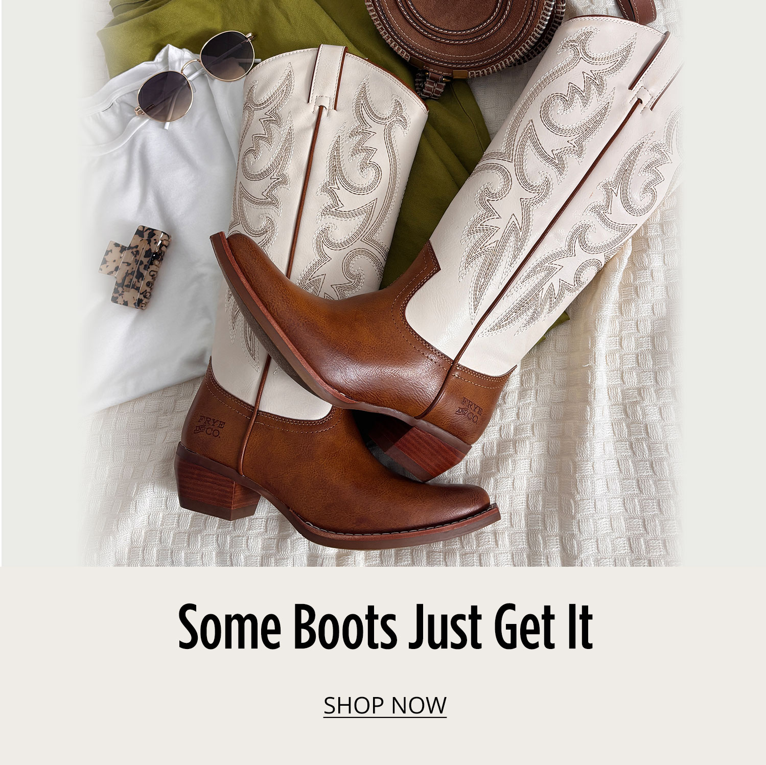 A pair of brown and white Frye & Co. western boots posed on white bedspread with accessories posed around them with text saying Some Boots Just Get It