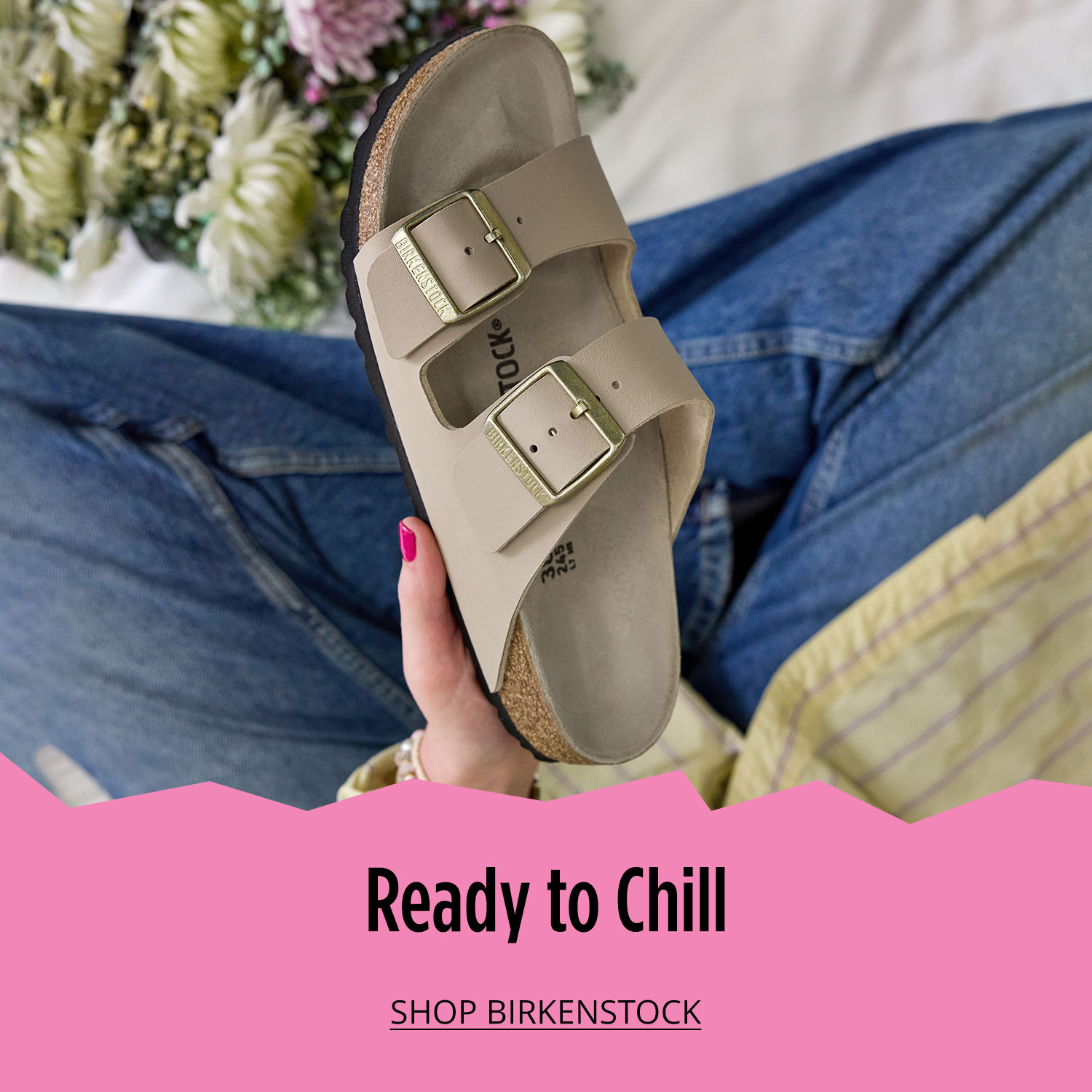 A pair of Birkenstocks on a women's lap 