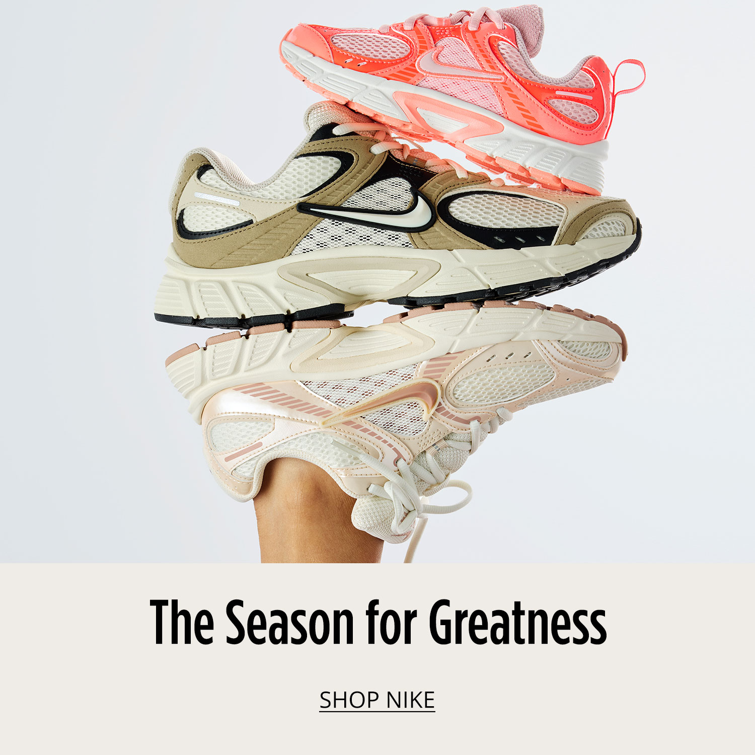 Three classic athletic sneakers from Nike for whole family are stack on top of each other on white background.