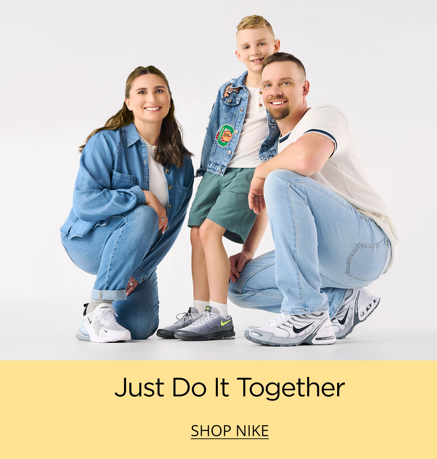 A mom, dad and their young son crouching close together representing their favorite brand, Nike as their ready to take on the day.