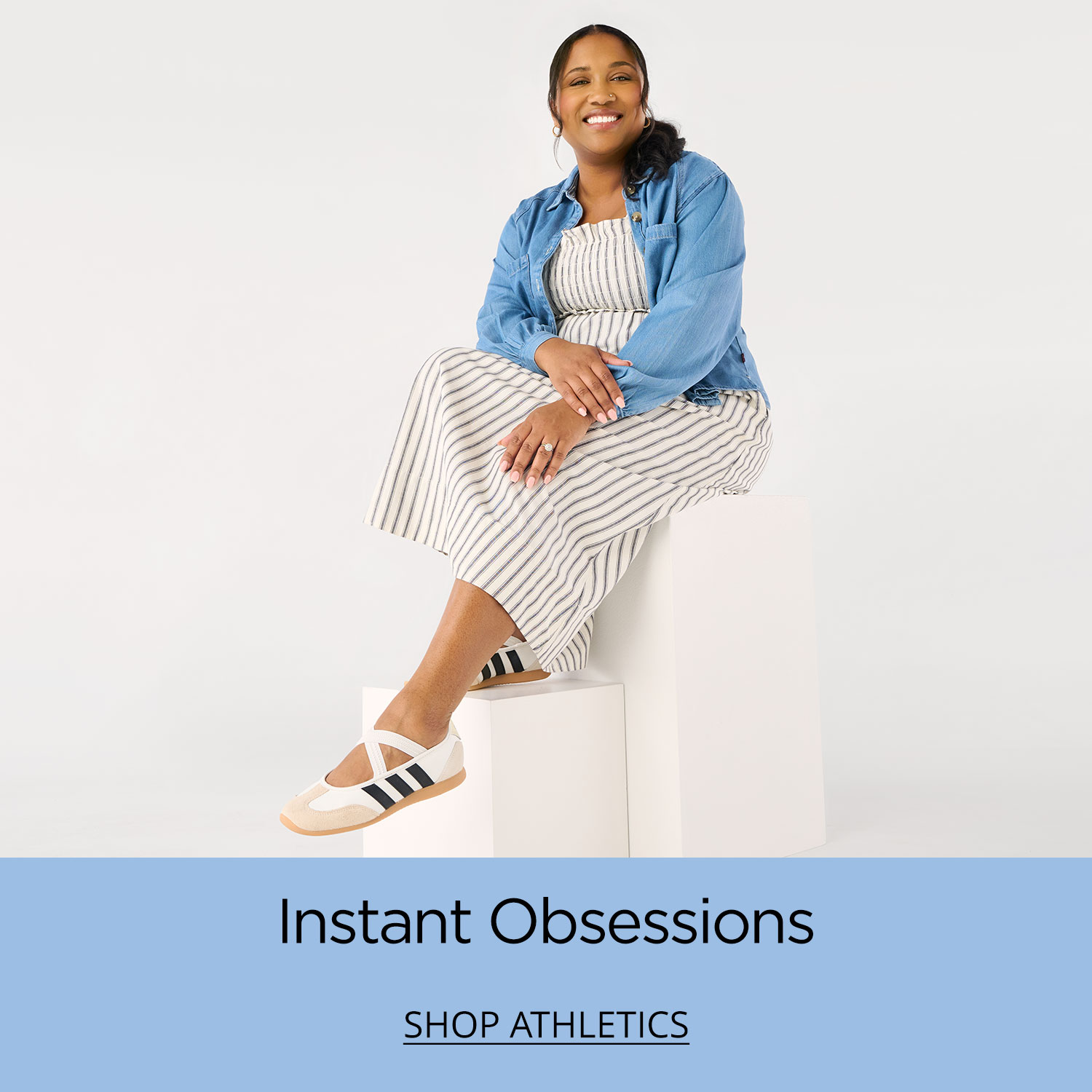 A mom sitting confidently on a plinth showing off her new white adidas Mary Jane Barreda sneakers.		
