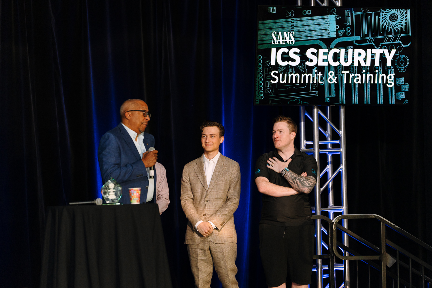 2024 Michael J. Assante ICS Security Lifetime Achievement Award Recipient, Zach Tudor with Alex Assante and Robert M. Lee