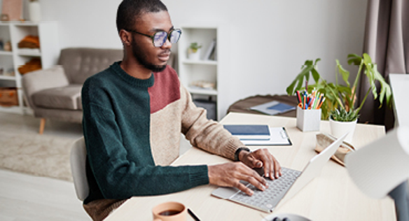 Man typing on laptop