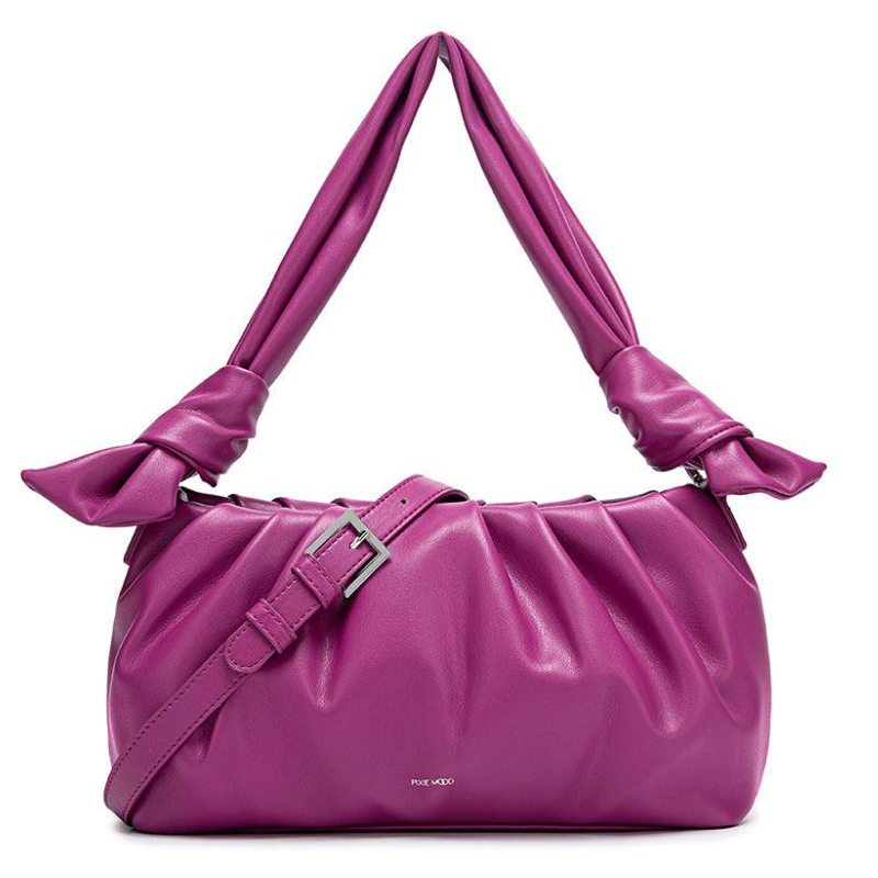 A magenta shoulder bag with a ruched design, featuring a wide, padded strap with knot details and a front buckle.