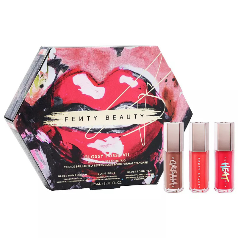 The Fenty Beauty Glossy Posse VII features a 3-piece full-size Gloss Bomb Trio, including Gloss Bomb Cream, Gloss Bomb, and Gloss Bomb Heat. Each gloss is 9ml, in shades of deep red cream, orange shimmer, and pink shimmer for versatile lip looks.