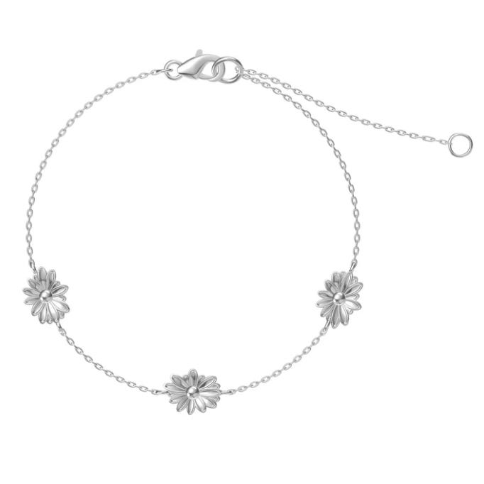 A silver chain bracelet with three small daisy-shaped charms, featuring a lobster clasp and an adjustable chain extension.