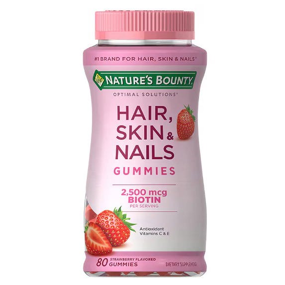 A bottle of Nature's Bounty Hair, Skin & Nails gummies with 2,500 mcg of biotin, flavored with strawberry, containing 80 gummies.