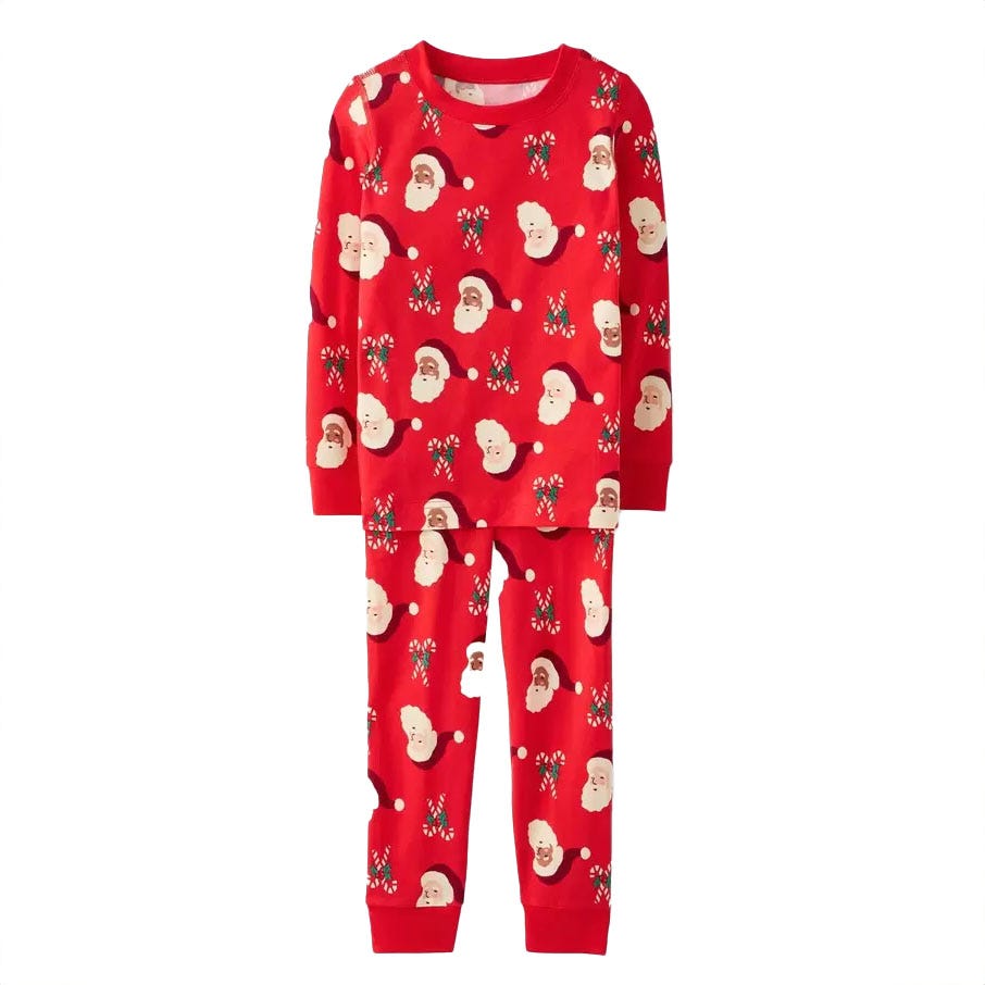 Red long-sleeve pajamas with matching pants featuring festive holiday-themed patterns, including Santa faces and snowflakes.