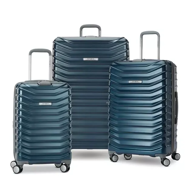 Three sizes of blue, ribbed hard-shell suitcases with telescoping handles and four wheels.