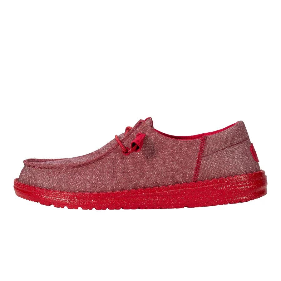 Hey Dude Wendy Funk Mono Sparkle Shoes feature a red, glittery finish with a casual design, including a low-profile silhouette, lace-up closure, and a comfortable red sole.