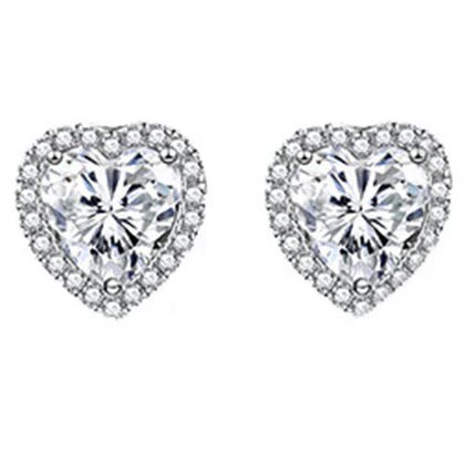 Sterling Silver Heart Studs feature heart-shaped gems surrounded by a halo of smaller stones, creating a sparkling, elegant look.