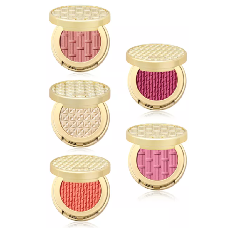Five Tarte Cosmetics cheek powders in gold cases, featuring various woven and geometric patterns. The shades include pink, magenta, beige, coral, and light mauve.