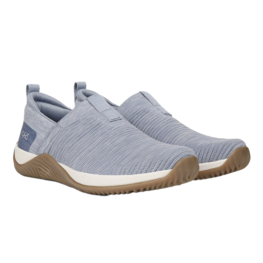 Ryka Echo Knit Slip-On Sneakers feature a light blue knit upper with a slip-on design, cushioned midsole, and tan rubber sole for traction. They have a streamlined look and a pull-tab for easy wear.