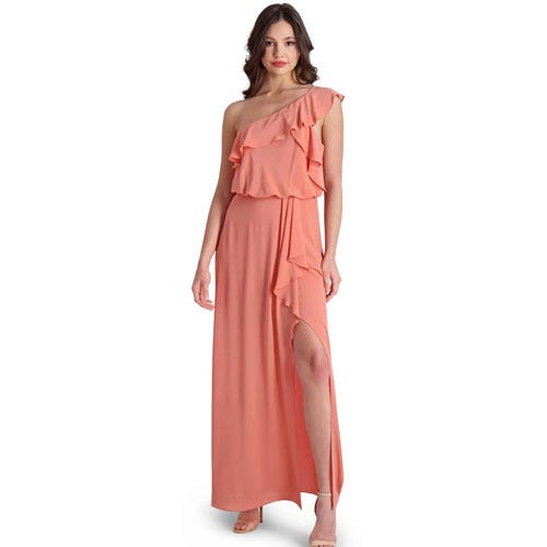 Woman wearing a one-shoulder peach maxi dress with a ruffle detail and a thigh-high slit.