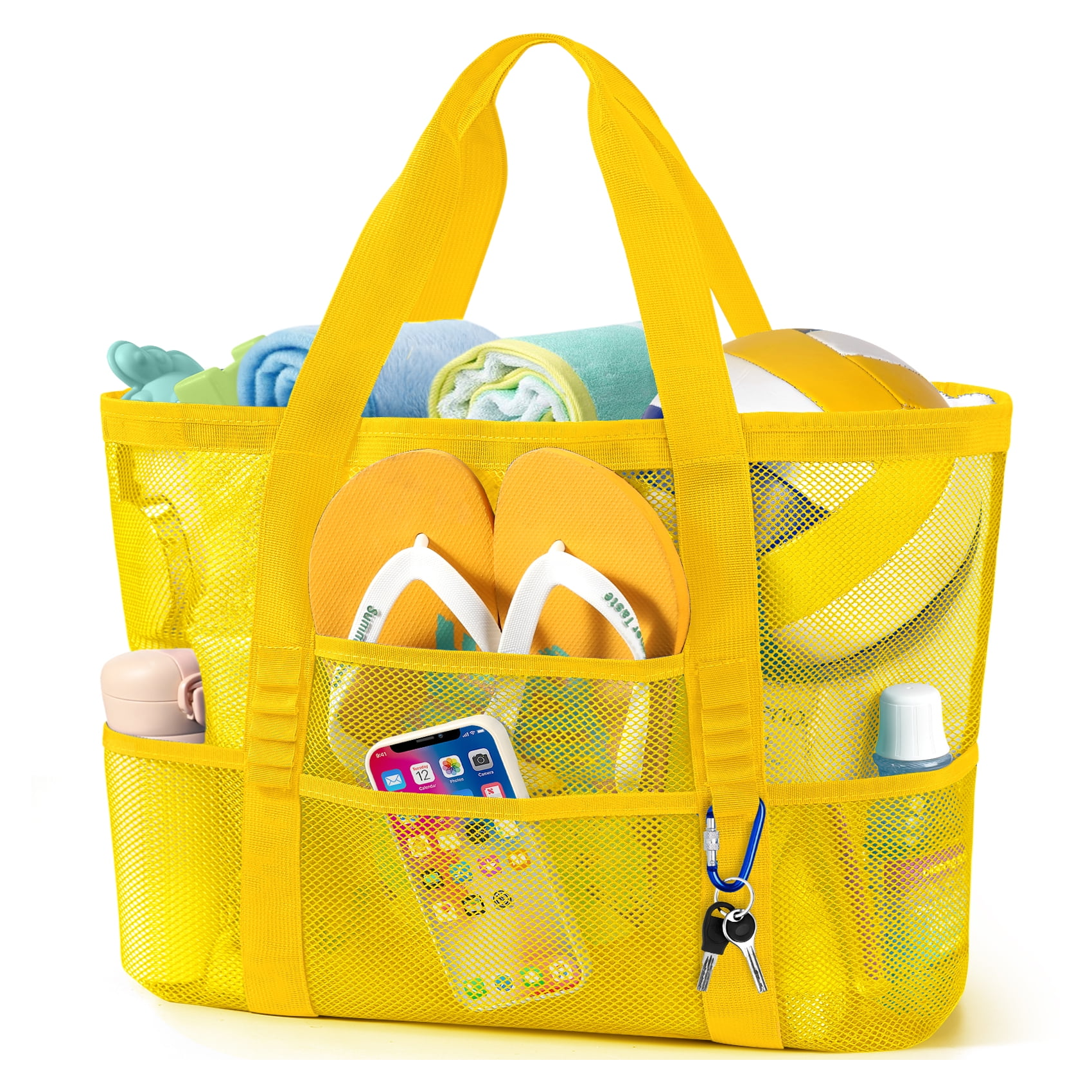 A yellow mesh beach bag contains flip-flops, a smartphone, a towel, a volleyball, sunscreen, a water bottle, and keys.
