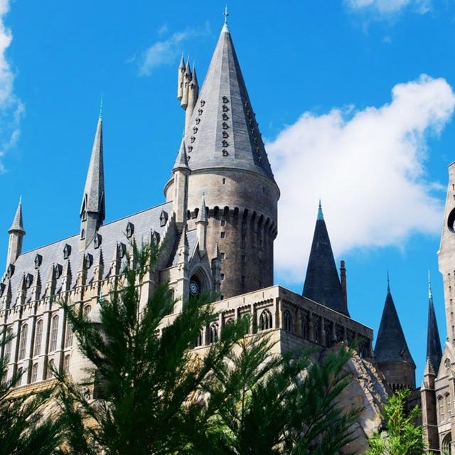 The photo shows a castle with tall spires against a blue sky, reminiscent of Gothic architecture.