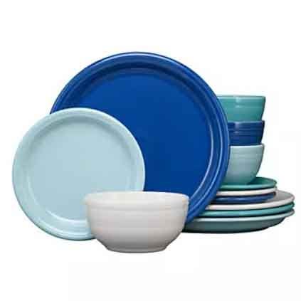 The Fiesta Chip-Resistant Dinnerware Set includes a variety of plates and bowls in blue hues. The set features a sturdy, chip-resistant design, perfect for everyday use.