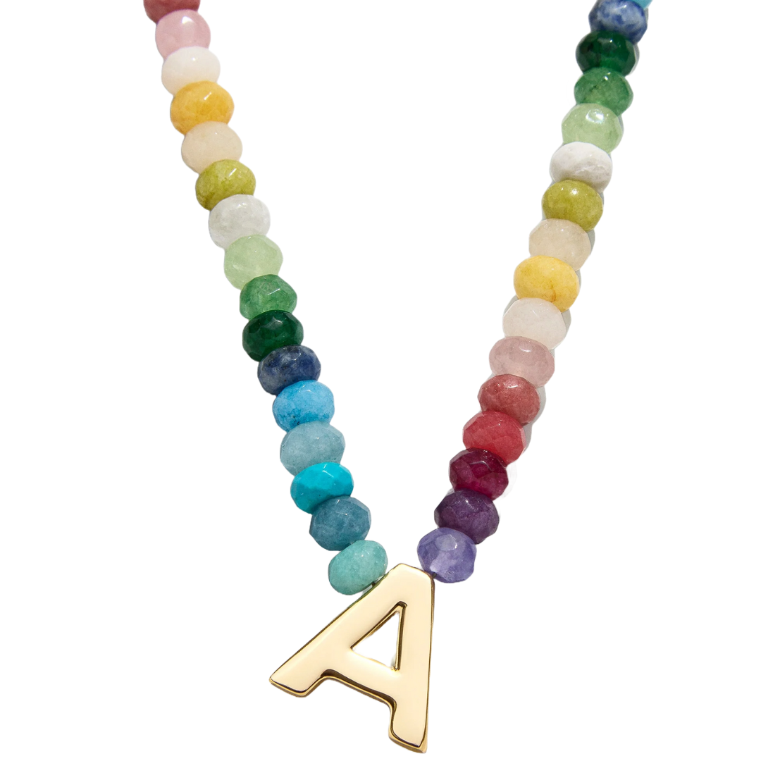 A colorful beaded necklace featuring a gold pendant in the shape of the letter \“A\“.