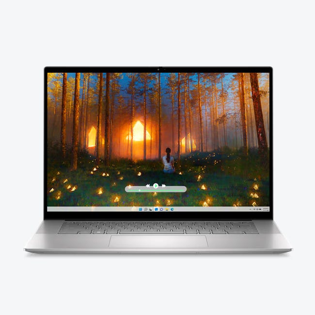 Laptop with a large screen displaying a forest with warm sunlight and fireflies.